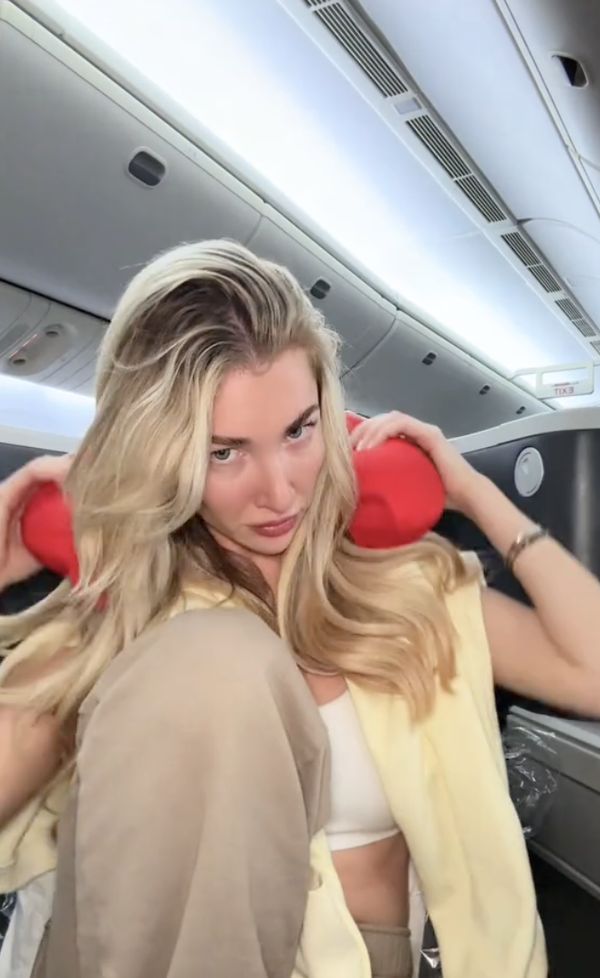 Kate Cassidy holding a travelling neck pillow | Source: tiktok.com/@katecass